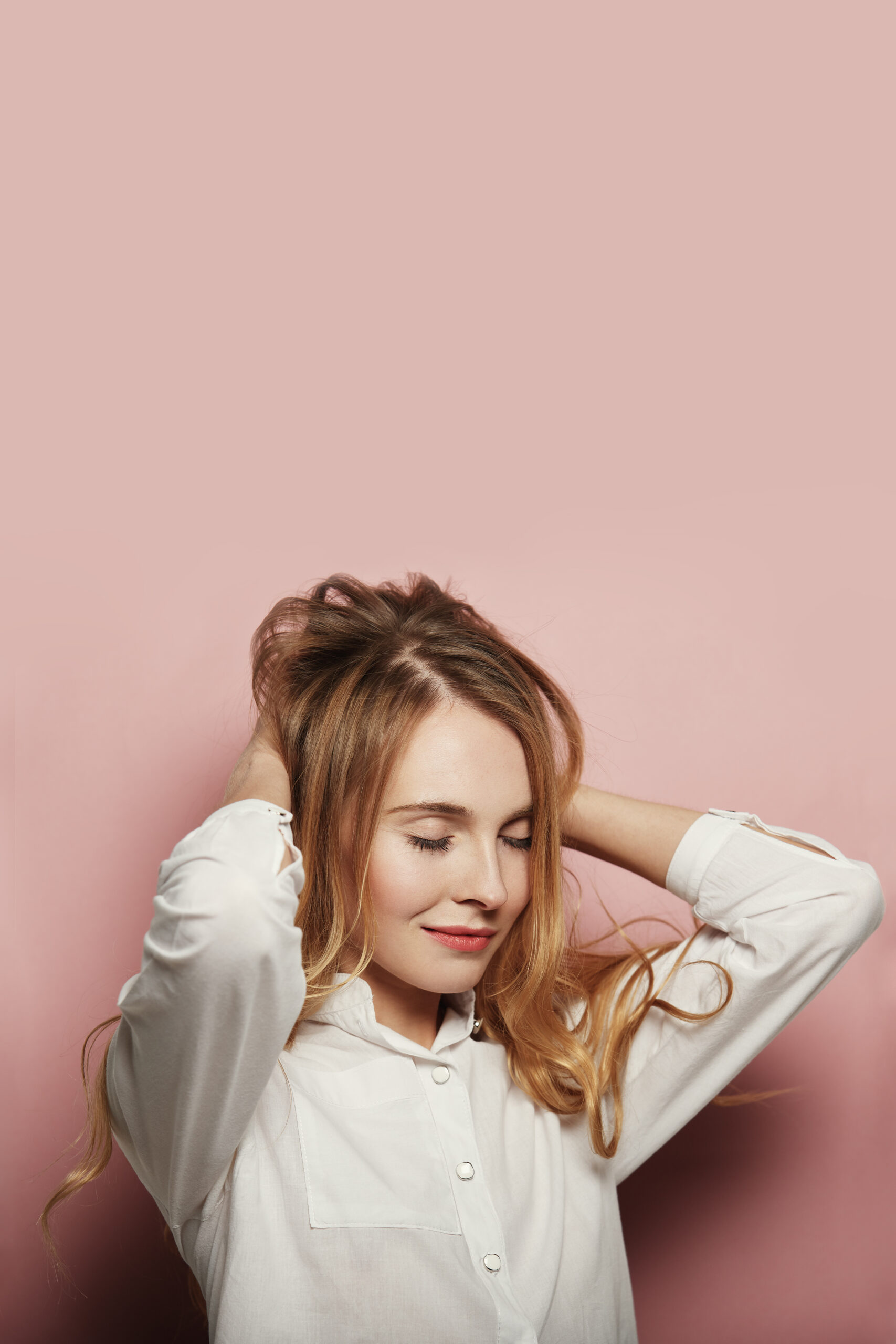 pretty young woman posing pink background scaled.jpg