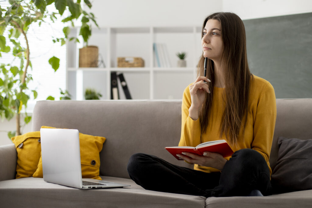 full shot woman couch thinking