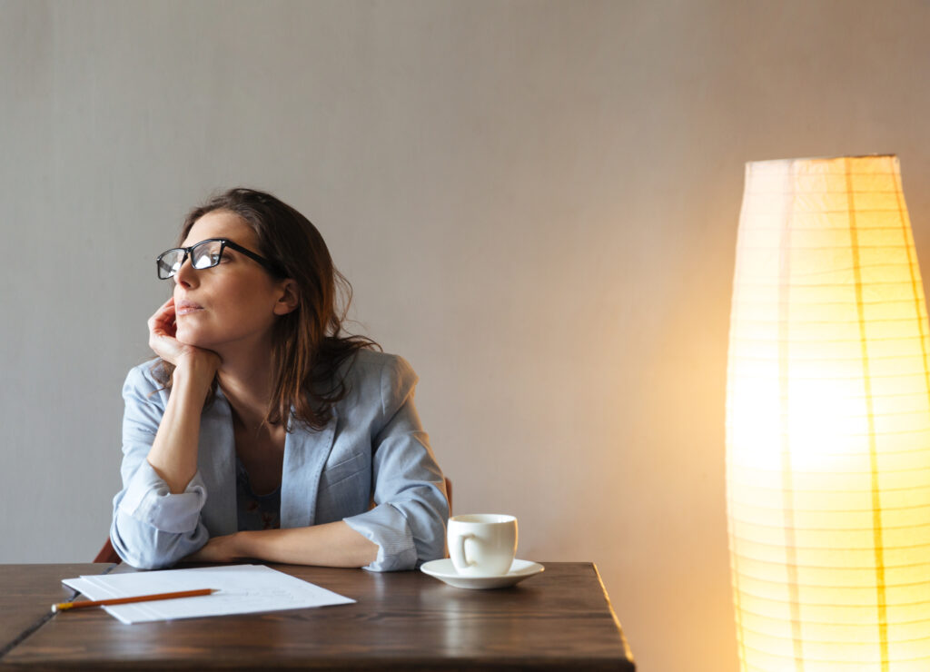 thoughtful woman writing notes.